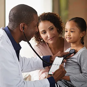 Littmann 3M CORE Digital Stethoscope Black Chestpiece Tube Stem and Headset 69 cm 8490 Black / Black Chestpiece Single - A doctor using the Littman Stethoscope on a young patient whilst using the Littman phone app