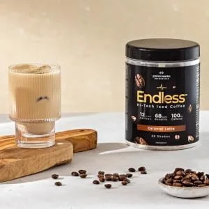 Protein Works - Endless Coffee | for Brain and Cognitive Support | Zero Crash No Added Sugar | Caramel Latte - 460g - Endless coffee in glass with ice next to coffee beans