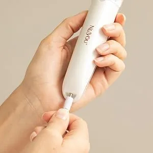 JML NuYou Pedi Roller - rechargeable pedicure tool being plugged in to charge