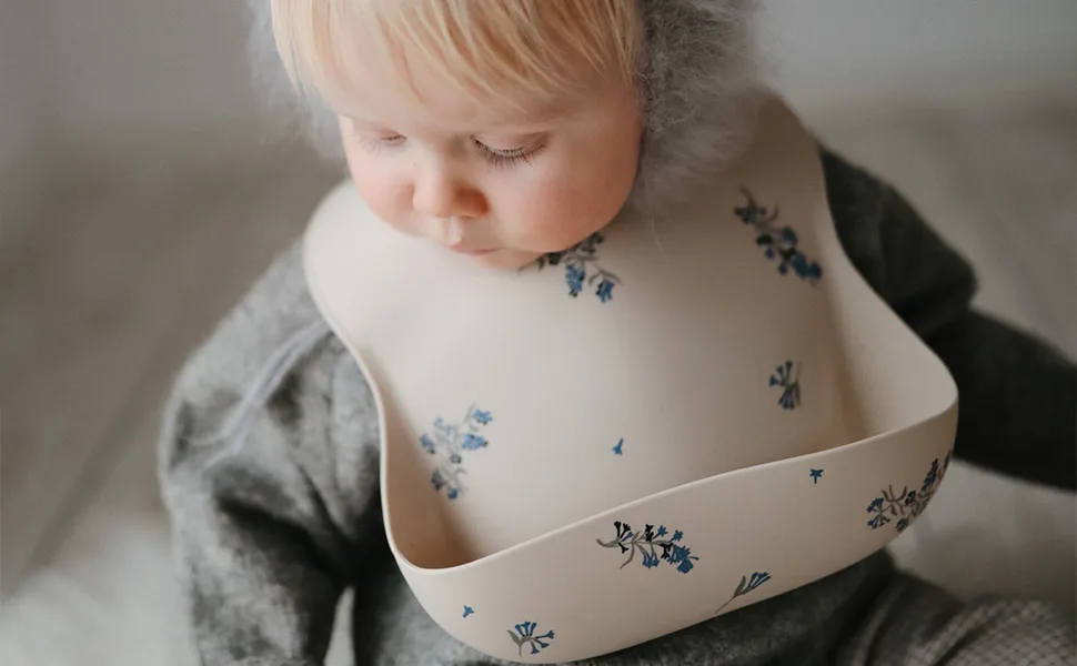 Mushie Baby Silicone Bib | Adjustable Fit Waterproof Bibs | Easy Wipe Baby Feeding Bibs | 4 Adjustable Sizes with Deep Front Pockets | 100% BPA and Phthalate Free Whales - Mushie Bib